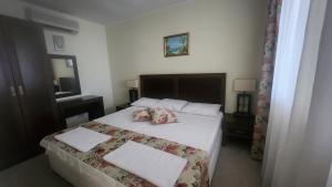 a bedroom with a bed with two pillows on it at Apartment Sunset resort C8-24 in Pomorie