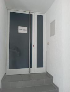 a glass door with a sign on it in a room at Monteurwohnung Monti 2 in Saarbrücken +1 photo