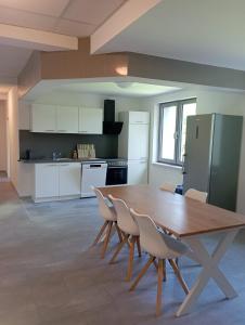 a large kitchen with a wooden table and chairs at Monteurwohnung Monti 2 in Saarbrücken