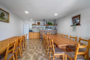 a dining room with a large wooden table and chairs at Petar in Kalnik