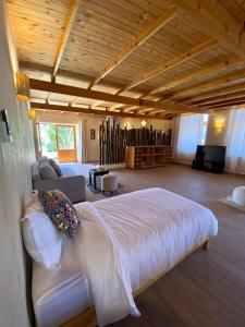 a bedroom with a bed and a couch in a room at RIAD LES DEUX MONDES in Essaouira +42 photos