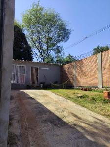 a brick building with a hammock on the side of it at Comfortable and practical house in Asuncion