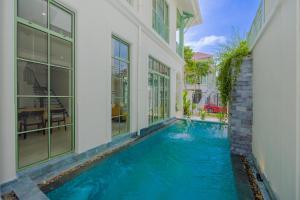 a swimming pool in the middle of a house at Fortune Villa- Swimming pool at Kem Beach Phu Quoc in Phu Quoc