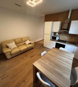 a living room with a table and a couch at Lecco lake Visconti in Lecco