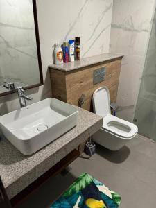 a bathroom with a sink and a toilet at Goldcrest Luxury Serviced Apartments DHA Phase 4 Lahore Near Airport & MM Alam Road in Dargai