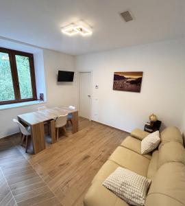 a living room with a couch and a table at Lecco lake Visconti in Lecco +1 photo