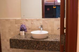 a bathroom counter with a white sink and a mirror at Goldcrest Luxury Serviced Apartments DHA Phase 4 Lahore Near Airport & MM Alam Road in Dargai +54 photos