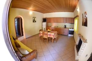 a kitchen and dining room with a table and chairs at Yannis' Village in Keri