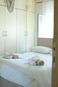 a white bed with towels on top of it at Stella's Home in Čitluk