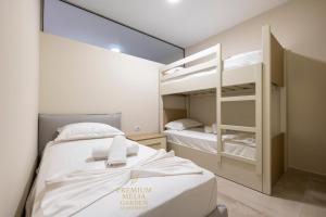 a bedroom with two bunk beds and a mirror at Premium Melia Garden Apartment in Lalzit Bay +59 photos