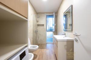a bathroom with a toilet and a sink and a shower at Premium Melia Garden Apartment in Lalzit Bay