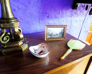 a wooden table with a picture and a spoon on it at The Bleu Guitar Suite in Saint Louis +5 photos