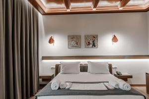 a bedroom with a bed with towels on it at Sharm Hotel Luxury in Gjirokastër