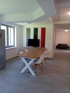 a room with a table and chairs and a television at Monteurwohnung Monti 2 in Saarbrücken