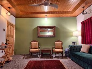 ein Wohnzimmer mit einer Couch und zwei Sesseln in der Unterkunft Serene in Gilgit