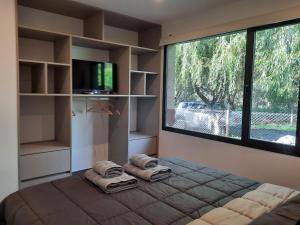 a bedroom with a bed and a large window at Casa Lavanda in Sierra de los Padres