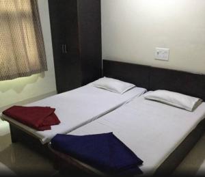 那格浦尔Hotel Parth的带两张单人床的客房 - 带背风性关节炎