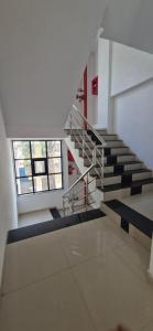 a spiral staircase in a building with two windows at Hotel Maharaja Inn in Pune