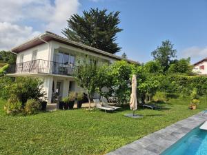 a villa with a swimming pool and a house at Chambre double avec salle de bain privative in Hendaye