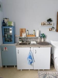 a kitchen with a sink and a counter at Bluefullstop-Μπλε Τελεία in Artemida +29 photos