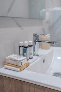 a bathroom counter with books and other items on it at Duplex in Piraeus' Best Street 2Bath w-FreeParking in Piraeus +28 photos