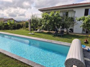 a swimming pool in front of a house at Chambre double avec salle de bain privative in Hendaye