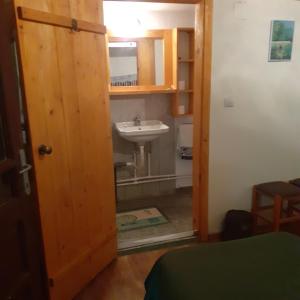 a bathroom with a sink and a mirror and a door at Dui Brazi in Cuied +44 photos