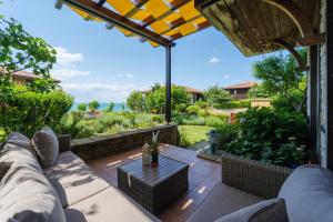 a patio with a couch and a table at Luxury 3-bedroom villa in Sozopolis with sea view in Sozopol