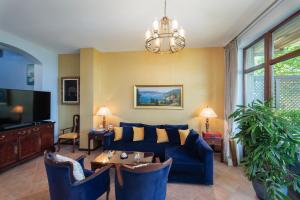 a living room with a blue couch and a tv at Luxury 3-bedroom villa in Sozopolis with sea view in Sozopol