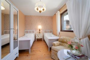 a hotel room with two beds and a couch at Luxury 3-bedroom villa in Sozopolis with sea view in Sozopol