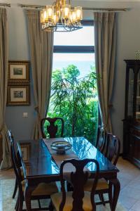 a dining room with a table and a large window at Luxury 3-bedroom villa in Sozopolis with sea view in Sozopol +18 photos