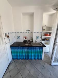 a kitchen with a sink and a counter top at Fantasy House 2.0 in Forio d'Ischia
