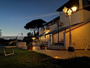 a house with a street light in the yard at night at Fantasy House 2.0 in Forio d'Ischia
