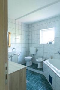 a bathroom with a tub and a toilet and a sink at Stella's Home in Čitluk +10 photos