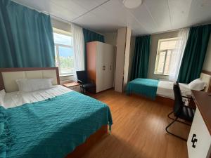 a hotel room with two beds and green curtains at Rom Etuga guesthouse in Ulaanbaatar