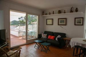 a living room with a couch and a table at Apartment 1st sea line in Sa Tuna, Begur H85 in Isla Negra