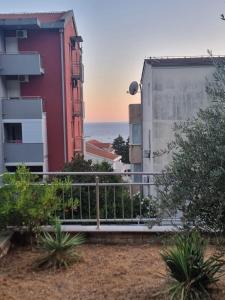 a view of the ocean from the balcony of a building at two bedroom apartment with parking in Petrovac na Moru