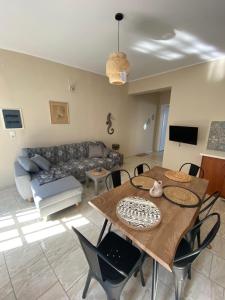 a living room with a table and a couch at Violeta in Agios Kirykos