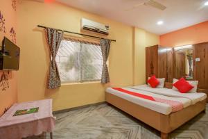 Postel nebo postele na pokoji v ubytování Super Hotel O Priyal Amrit Sagar + 37 fotografií