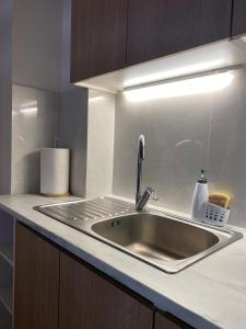 a kitchen counter with a sink in a kitchen at Cosy Nest In Samos in Samos +22 photos