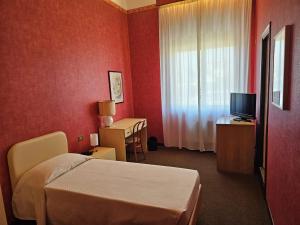 Posteľ alebo postele v izbe v ubytovaní Hotel Corona