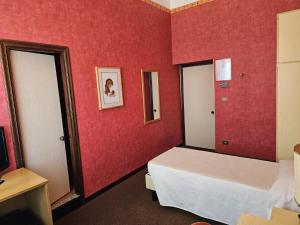 Posteľ alebo postele v izbe v ubytovaní Hotel Corona