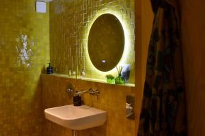 a bathroom with a sink and a mirror at Modern seaside barn in Borrby +28 photos