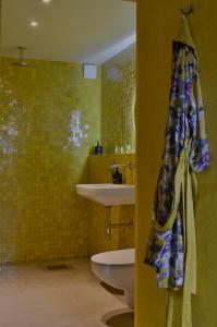 a bathroom with a sink and a toilet at Stylish seaside barn in Borrby +32 photos