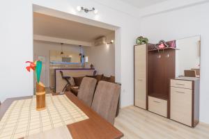 a kitchen and a dining room with a table and a room with a kitchen at Apartment Ines in Bar