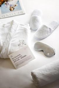 a group of white towels and shoes on a table at The St. Regis Chengdu in Chengdu