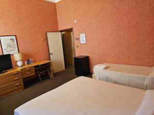 Posteľ alebo postele v izbe v ubytovaní Hotel Corona