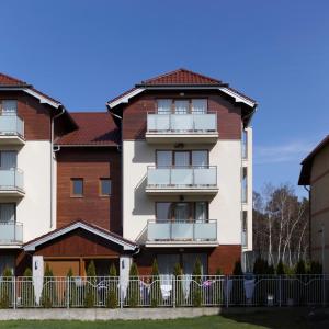 an apartment building with a fence in front of it at Villa Nova 34A in Hel