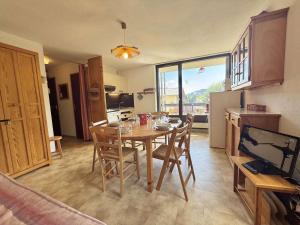 a kitchen and dining room with a table and chairs at Appartement 3 pièces à Flumet avec parking, 6 personnes - FR-1-595-66 in Flumet +10 photos
