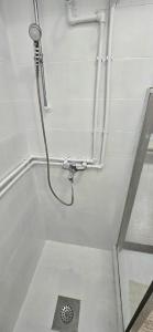 a shower in a bathroom with a drain in the floor at Alpha Casa in Bar